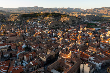 Obraz premium Aerial view of Spanish town of Calatayud located on scenic landscape of Sistema Iberico mountain range on sunny spring day, Province of Zaragoza