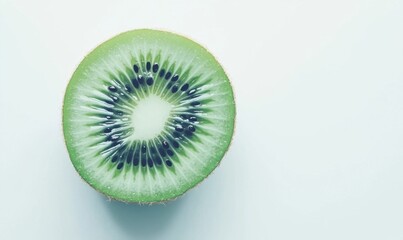 Freshly sliced kiwi showcasing vibrant green flesh and black seeds on a light background