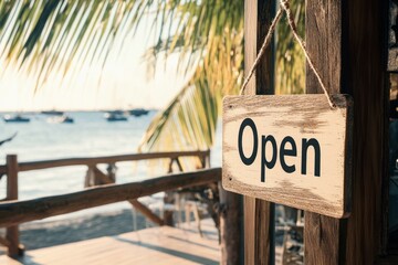 Fototapeta premium Beachfront business open sign under palm trees by ocean at sunset, inviting customers with tropical coastal ambiance