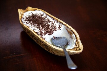 Traditional cupuaçu cream, cupuaçu mousse served in the fruit shell with grated chocolate
