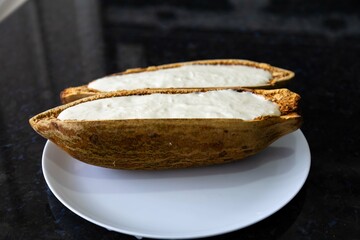 Traditional cupuaçu cream, cupuaçu mousse served in the fruit shell with grated chocolate