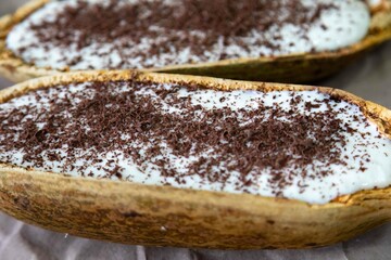 Traditional cupuaçu cream, cupuaçu mousse served in the fruit shell with grated chocolate