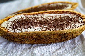 Traditional cupuaçu cream, cupuaçu mousse served in the fruit shell with grated chocolate