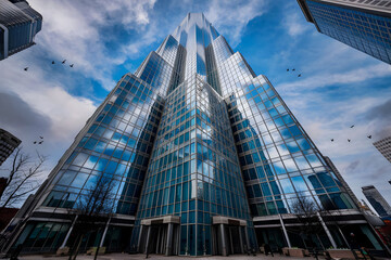 angle view of skyscraper with glass window and clear blue sky background for business and finance concept