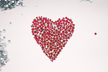 Beautiful heart is made of precious red crystals of rhinestones. Art background