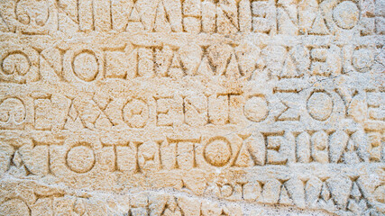 Close-up  background of ancient Greek writings on the ruins of an ancient city