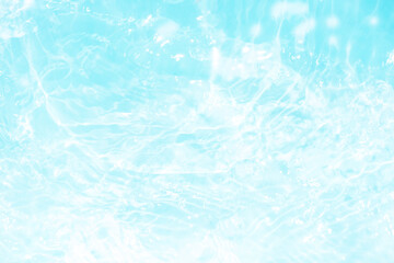 Blue water with ripples on the surface. Defocus blurred transparent blue colored clear calm water surface texture with splashes and bubbles. Water waves with shining pattern texture background.