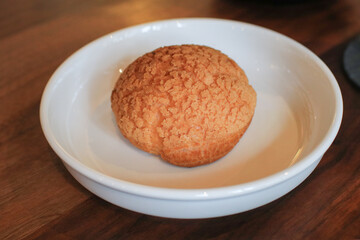 Craquelin Choux biscuits filled vanilla and milk custard on wooden table. Fresh Baked Bakery for coffee break or party