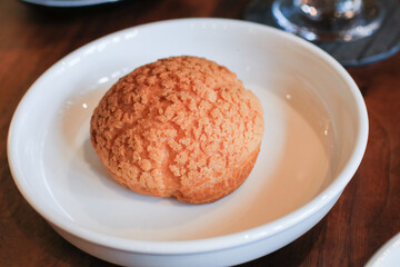 Craquelin Choux biscuits filled vanilla and milk custard on wooden table. Fresh Baked Bakery for coffee break or party