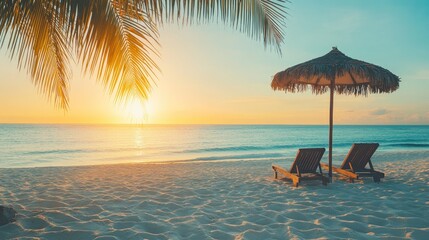 Serene beach sunset scene with sun loungers, umbrella, and palm fronds swaying in the breeze, soft white sand, and peaceful ocean stretching to the horizon. No people no text