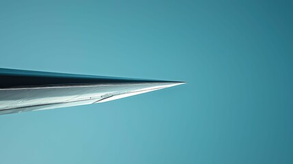 Detailed Side View of Aircraft Wing Cutting Through Blue Sky