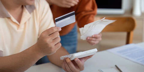 Couple discussing financial documents and credit card management, highlighting teamwork in...