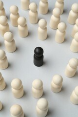 Stop racism. Black human figure among white ones on light background
