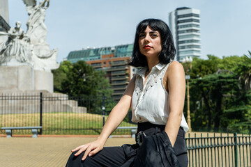 Elegant latin businesswoman relaxing in a city park in montevideo