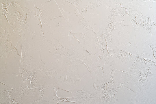 Minimalist taupe gray painted wall with textured finish, perfect for modern interiors. This clean surface adds touch of elegance to any space