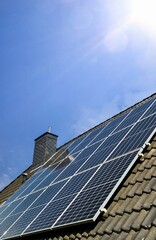 Solar panels producing clean energy on a roof of a residential house