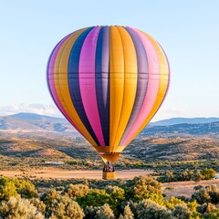 Fototapeta premium Colorful hot air balloon soaring over a scenic landscape during sunset