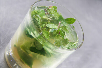 Vibrant Cuban Mojito in an old-fashioned glass with fresh mint, lime, and a hint of brown sugar, perfect for summer refreshment.