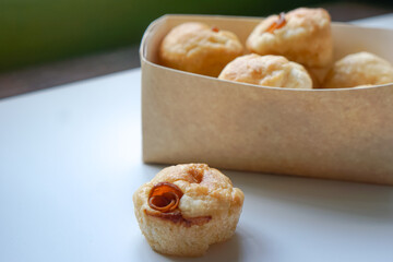 Close up view of Sourdough Focaccia Bread Muffins with pepperoni on white background in selective focus.