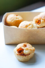 Close up view of Sourdough Focaccia Bread Muffins with pepperoni on white background in selective focus.