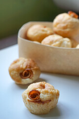 Close up view of Sourdough Focaccia Bread Muffins with pepperoni on white background in selective focus.