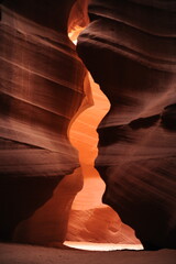 Ethereal light illuminates the flowing sandstone walls of Antelope Canyon, showcasing nature's art in vertical format