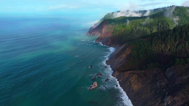 PNW Lost Coast Trail rugged dramatic untouched coastline aerial drone California surf waves boulder rocks USAL Beach campground cloudy shaded mist fog sun rays morning nature landscape forward