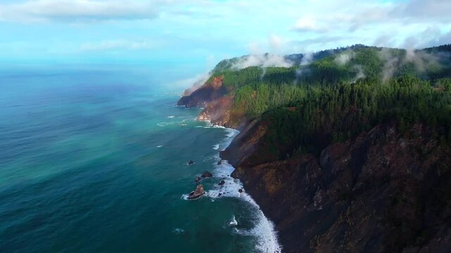 PNW Lost Coast Trail rugged dramatic untouched coastline aerial drone California surf waves boulder rocks USAL Beach campground cloudy shaded mist fog sun rays morning nature landscape circle left