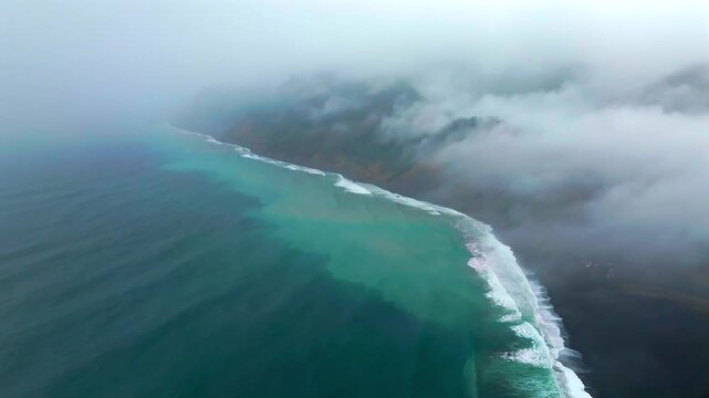Waves crashing boulder rocks rugged coastline black sand USAL Beach Campground Lost Coast Trail California aerial drone fog mist rain cloudy layers mountainside morning Pacific Ocean circle left