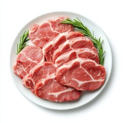 Freshly Sliced Pork Chops on White Plate with Green Rosemary Garnish Ready for Cooking or Grilling