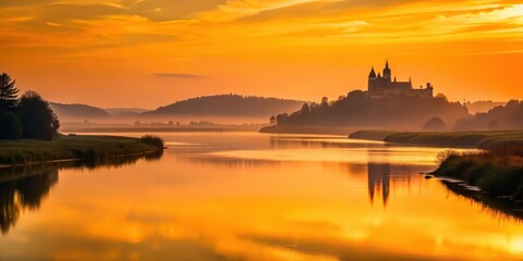 Fototapeta premium Golden Hour Serenity A Picturesque Castle Silhouette Reflected on Calm Waters at Dawn