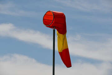 White and red striped wind sock. Strong wind and bad weather symbol. Climate Change. Weather...