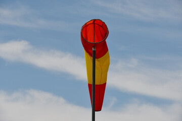 White and red striped wind sock. Strong wind and bad weather symbol. Climate Change. Weather...