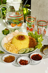 a complete plate of yellow rice which is Indonesian food