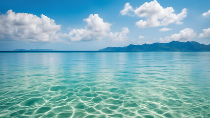 Obraz premium Crystal clear sea water bay. Pristine ocean lagoon water and sunny cloudy sky. 