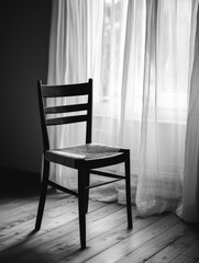 Wooden Chair by Sheer Window in Black and White