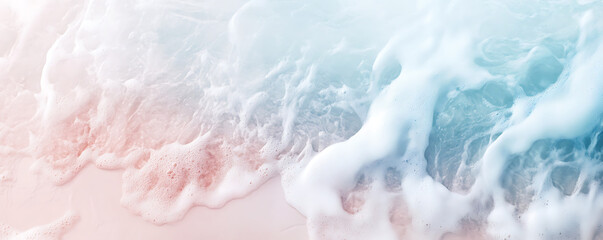 Obraz premium Gentle ocean waves caress the shore, blending soft colors of blue and pink.
