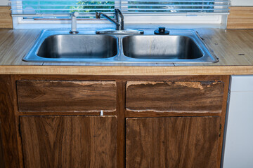 1970s vintage kitchen, dark brown cabinets, wood grain laminate counter tops, white walls and...