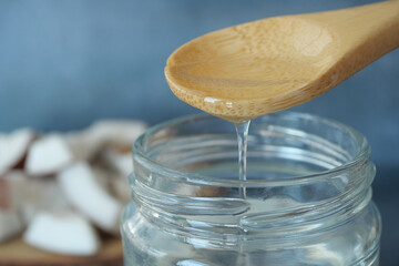 Pouring coconut oil in a jar 