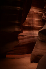 Whispering Shadows cavern in Antelope Canyon with orange rock formations silhouette and warm filtering light beams
