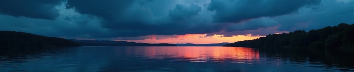 Dark ominous clouds gather over a lake at dusk, water, nighttime