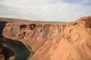 Expansive view of Horseshoe Bend and the surrounding desert landscape under a wide blue sky in Arizona tribal lands East Rim of the Grand Canyon