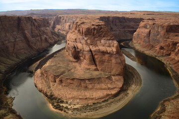 Overlooking the iconic Horseshoe Bend as the Colorado River winds through the stark desert landscape in Arizona tribal lands East Rim of the Grand Canyon