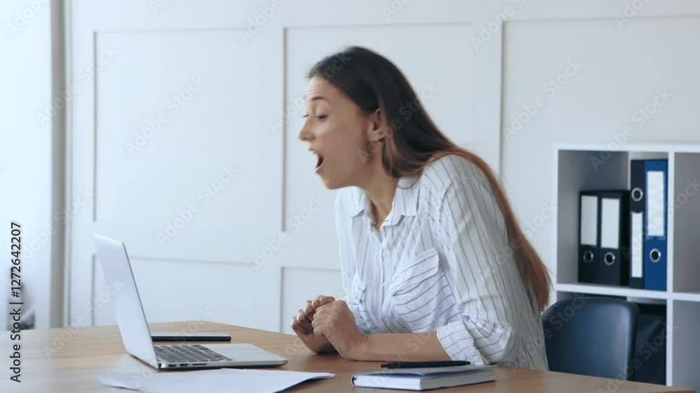 Poster a woman is focused on her work at a laptop in a well-lit office. the setting features light-colored 