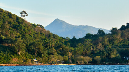 Kayaking to a Tropical Island with Majestic Mountain Peaks