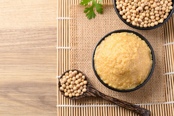 Miso paste in black bowl, Japanese seasoning made from fermenting soybeans with salt, Traditional...