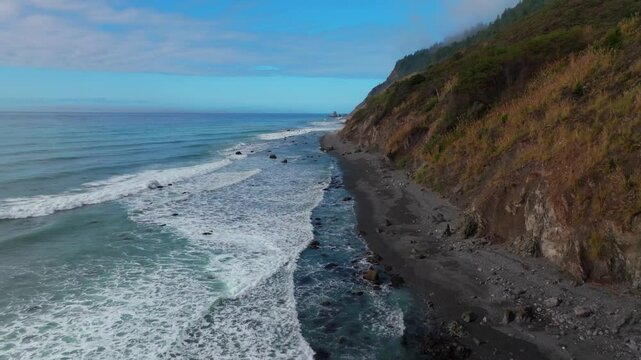 Waves Crashing black sand rugged coastline sunny morning blue sky mist fog layer USAL Beach Campground Lost Coast Trail Californi Pacific Ocean PNW Nor Cali boulders rocks mountainside forward motion