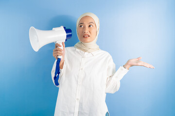 portrait of female holding megaphone with an expression of disgust