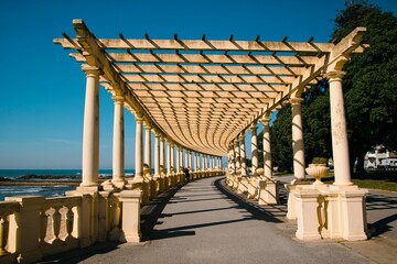 Long walkway with stone pillars leading to the beach area