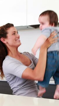 Happy mother playing with baby boy